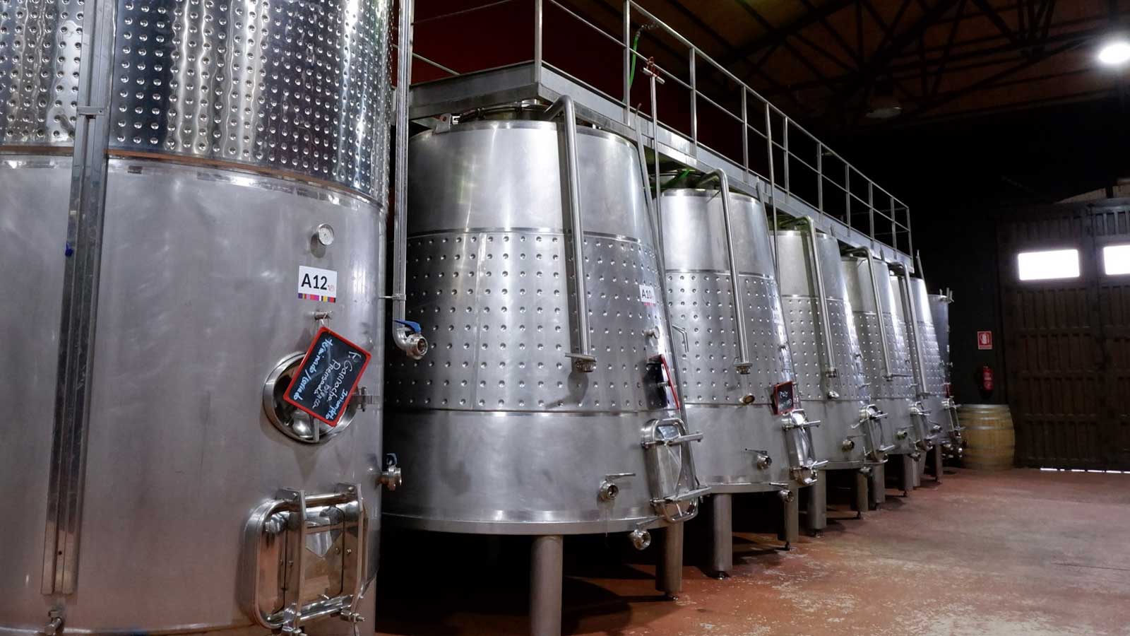 Stainless steel fermenting wine tanks in a Spanish winery